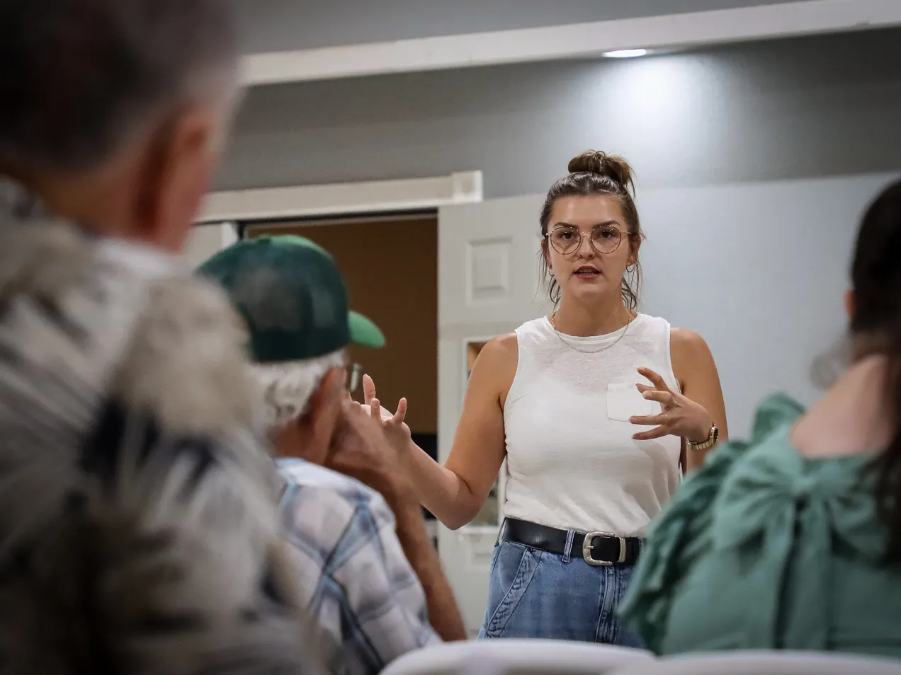 Hannah Cole speaking with voters at a community meeting